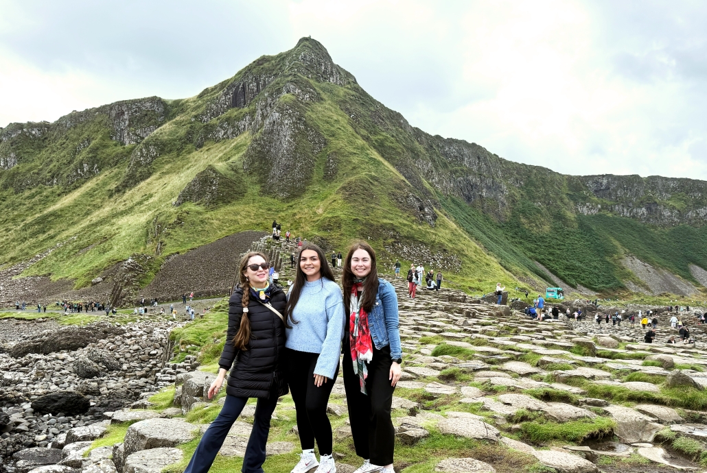 Three girls exploring the Giant’s Causeway in Northern Ireland on an Odyssey Coach Tour